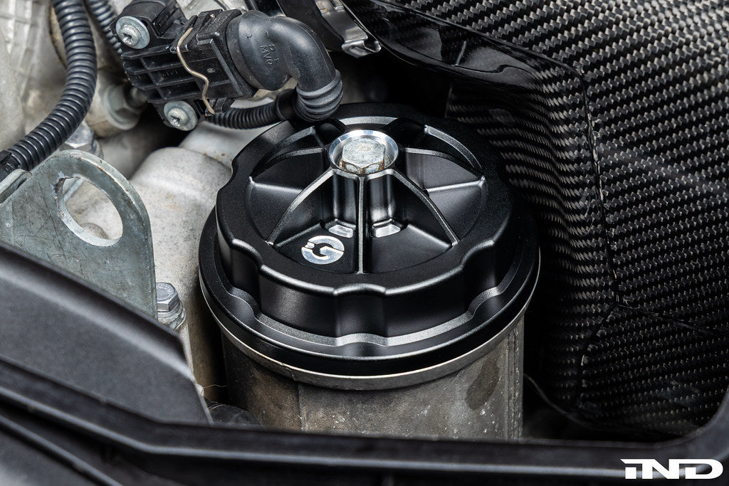 Goldenwrench BMW M50 S50 S52 S54 oil filter cap installed on engine, exterior view showing durable metallic finish.