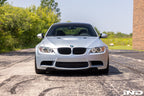 Front view of a black gloss exterior grille set for BMW E9X M3 by IND, installed on the vehicle.