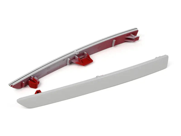 Close-up of the genuine BMW factory mounting clips on the IND F8X M3 and M4 Painted Rear Reflector Set against a white background, highlighting the OEM reflector assembly for direct factory fitment and installation.