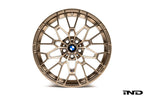 IND Gloss Black Wheel Center Cap Set for BMW, 56mm size, installed on gold wheels with a white background.