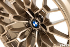 IND Gloss Black BMW wheel center cap set, 56mm Next Dark design installed on gold wheels, with a white background.
