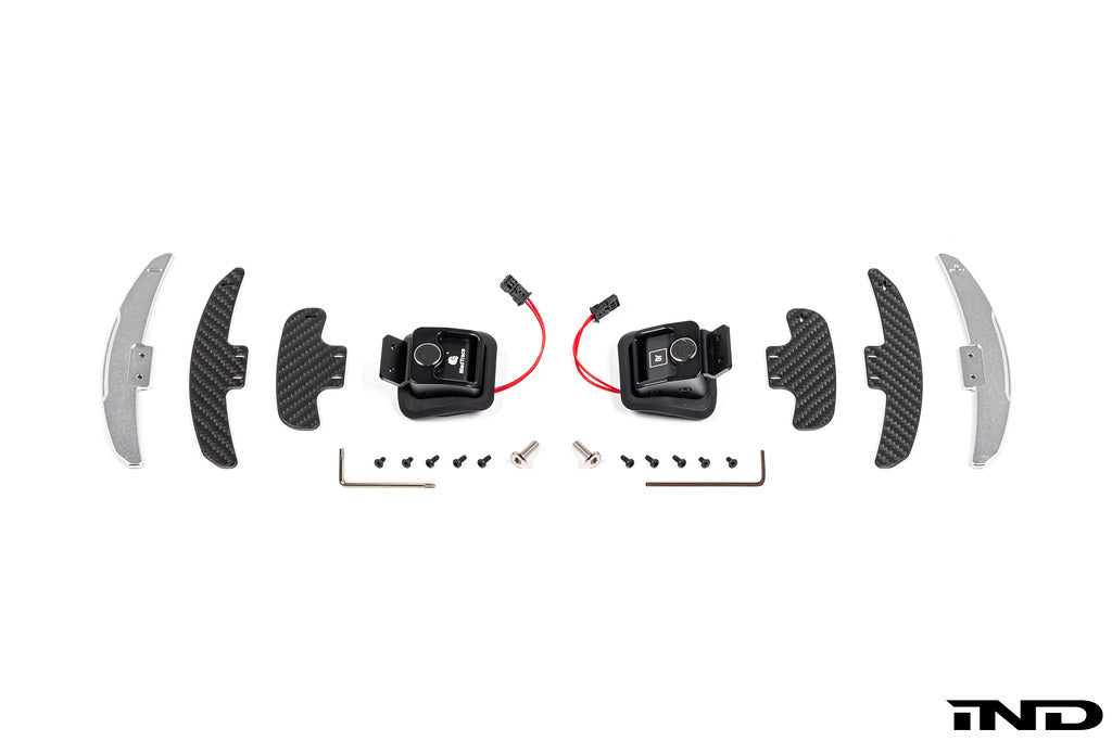 JQ Werks MadTrace BMW E-Chassis Clubsport magnetic shift paddle set installed inside a car, white background.
