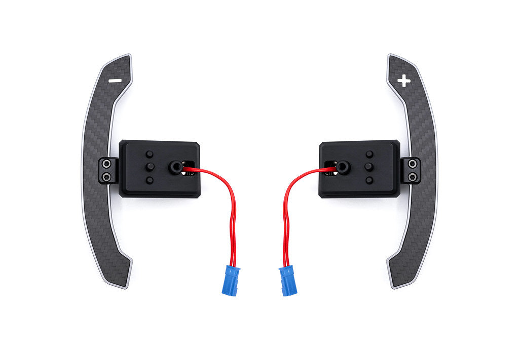 JQ Werks MadTrace BMW G-Chassis Clubsport Magnetic Shift Paddle Set in carbon V2 for interior upgrade, mounted on steering wheel.