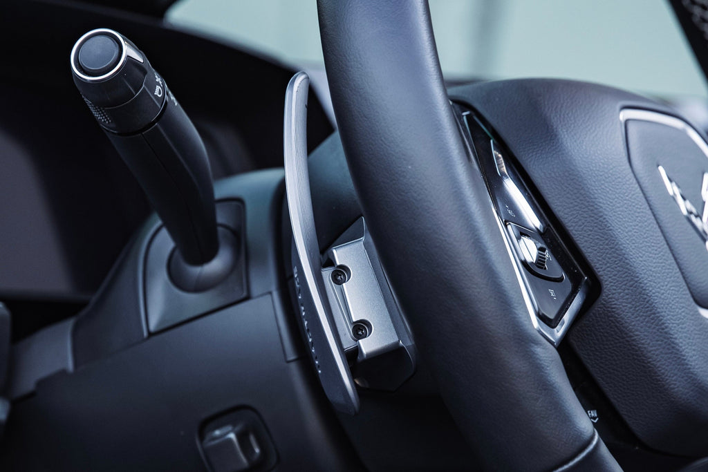 JQ Werks MadTrace C8 Corvette interior magnetic shift paddle set installed on steering wheel.