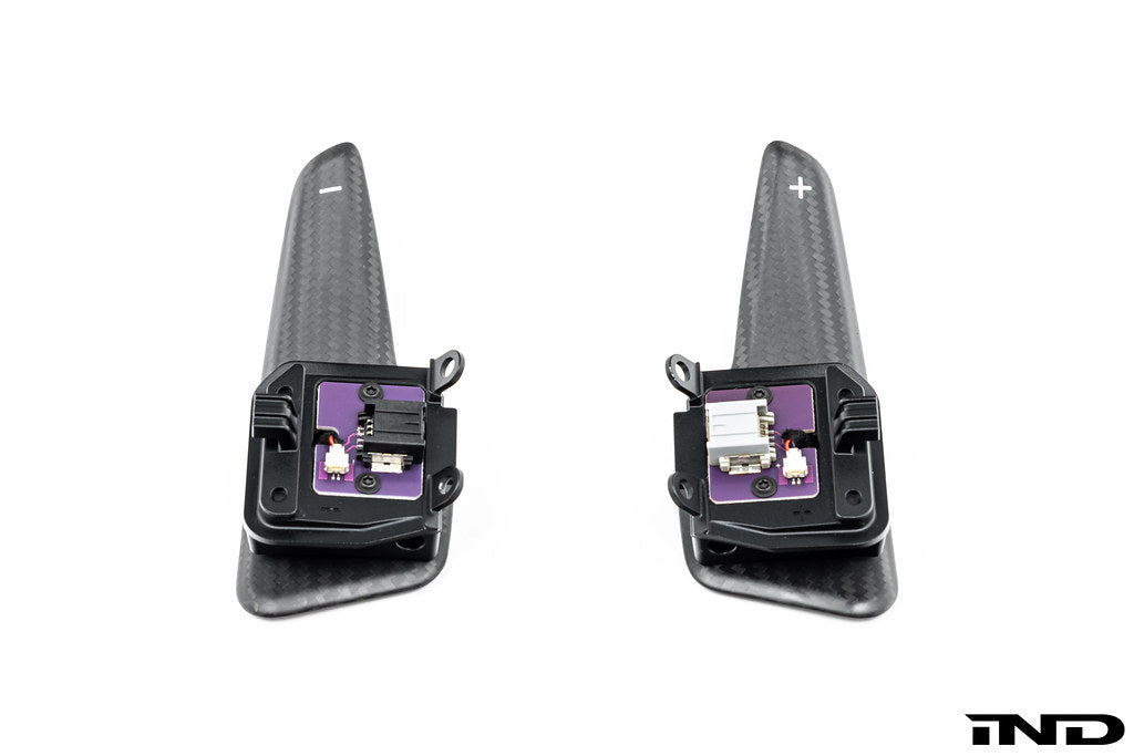 JQ Werks MadTrace C8 Corvette magnetic shift paddle set installed inside a car on a white background.