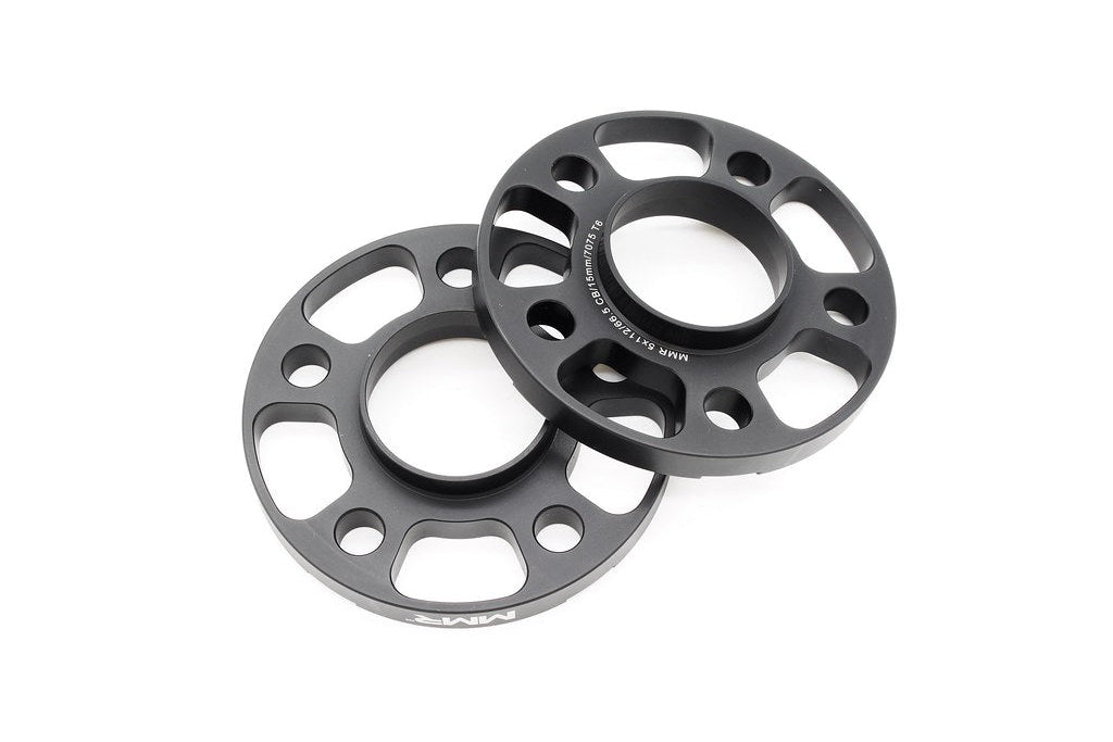 MMX Performance BMW / Supra 5x112 wheel spacer kit in black anodized finish with 12mm, 15mm, and 18mm spacers on wheels.
