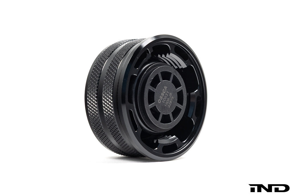 Black anodized MMX Performance BMW billet coolant expansion cap, 60mm, with detailed design on white background