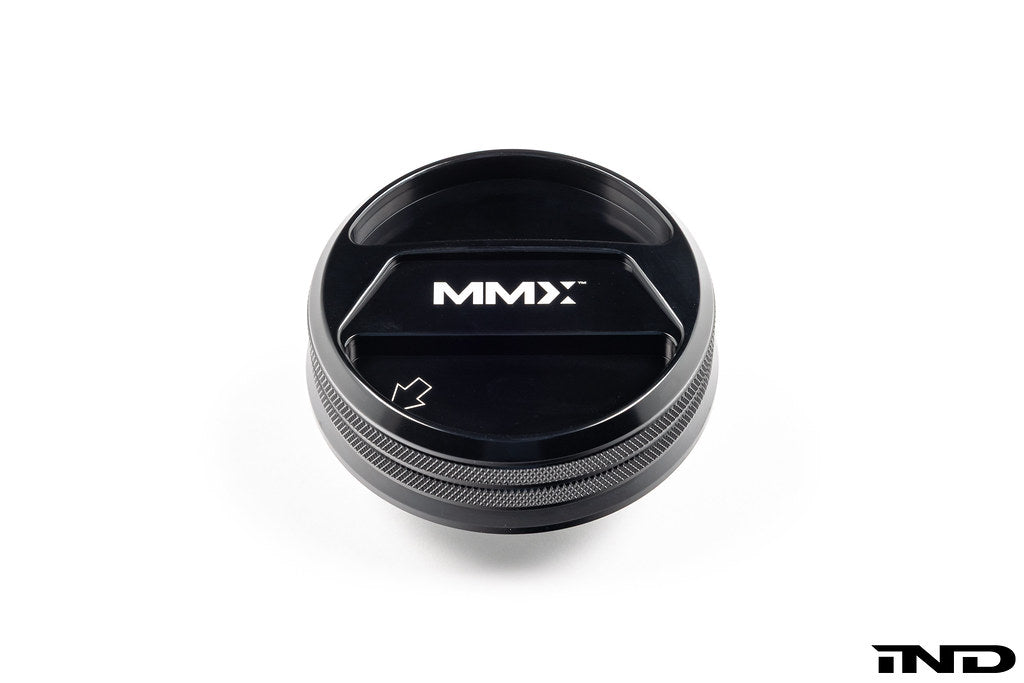 Black anodized MMX Performance BMW billet coolant expansion cap with 90mm diameter on white background.