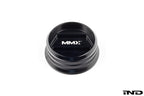 Black anodized MMX Performance BMW billet oil filler cap with engraved branding, designed for high-performance vehicle engine maintenance.