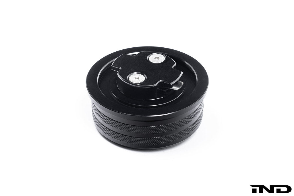 Black anodized MMX Performance BMW billet oil filler cap with sleek design, designed for BMW engine oil fill ports.