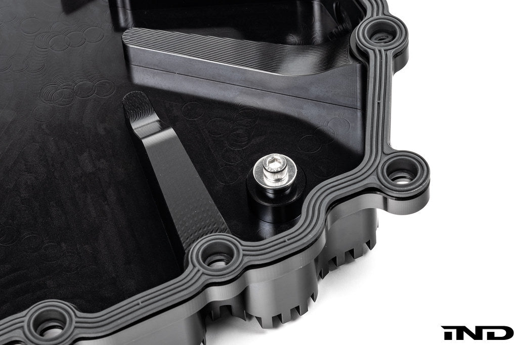 Black anodized aluminum BMW DCT oil pan by MMX Performance, designed for high-performance transmission cooling.