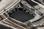 Black anodized MMX Performance aluminum BMW DCT oil pan installed on vehicle, designed for high-performance transmission cooling.