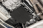 Black anodized MMX Performance aluminum BMW DCT oil pan installed on a vehicle, showcasing durable, high-performance automotive parts.