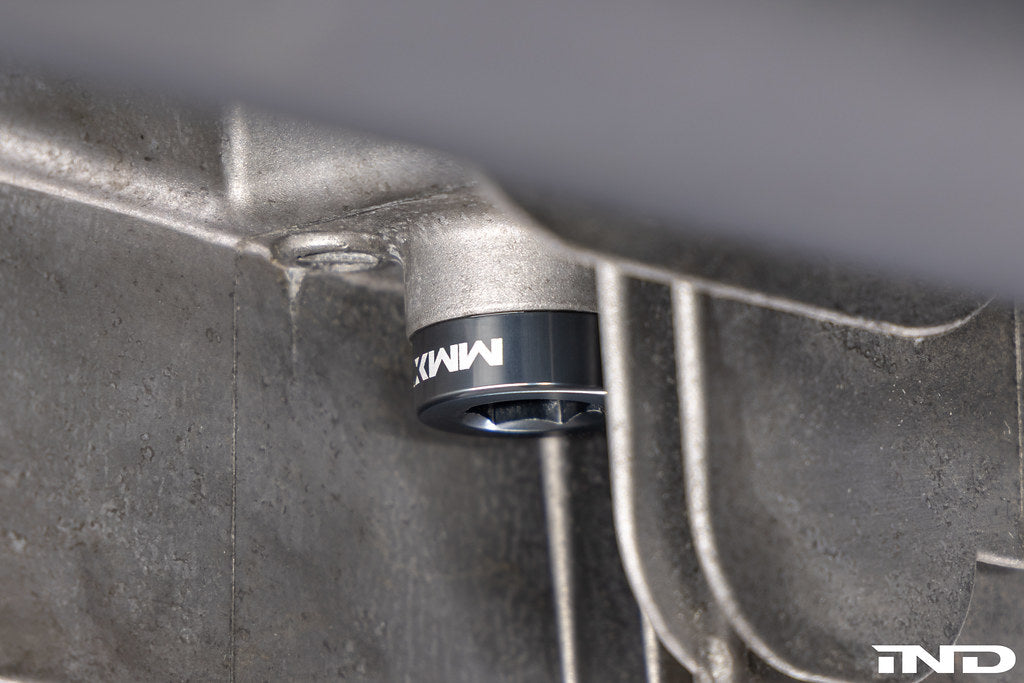 MMX Performance magnetic differential oil drain plug installed on a vehicle, M22x1.5 size, for improved fluid management and protection.