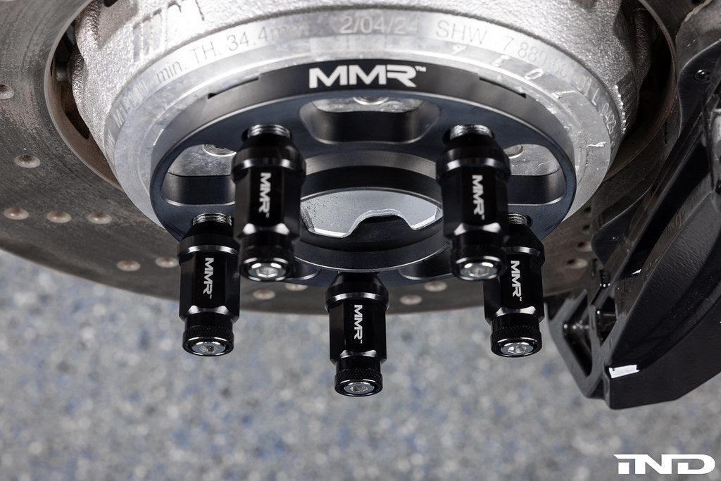 MMX Performance BMW wheel stud kit with M14x1.25 conical seat installed on a wheel for secure fastening.