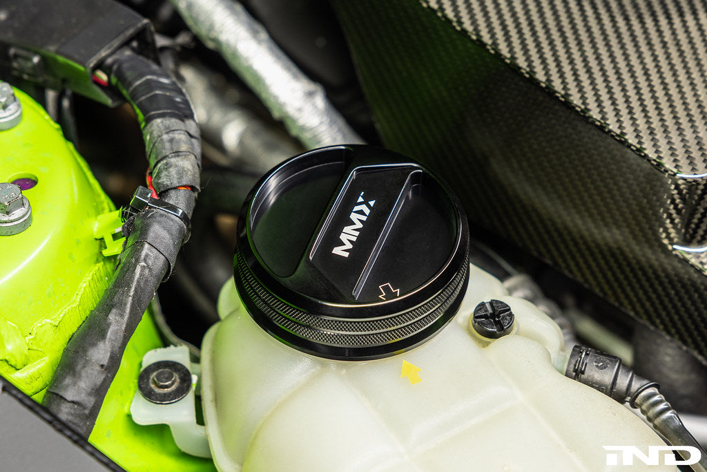MMX Performance BMW billet coolant expansion cap installed, showcasing a sleek, high-performance engine upgrade accessory.