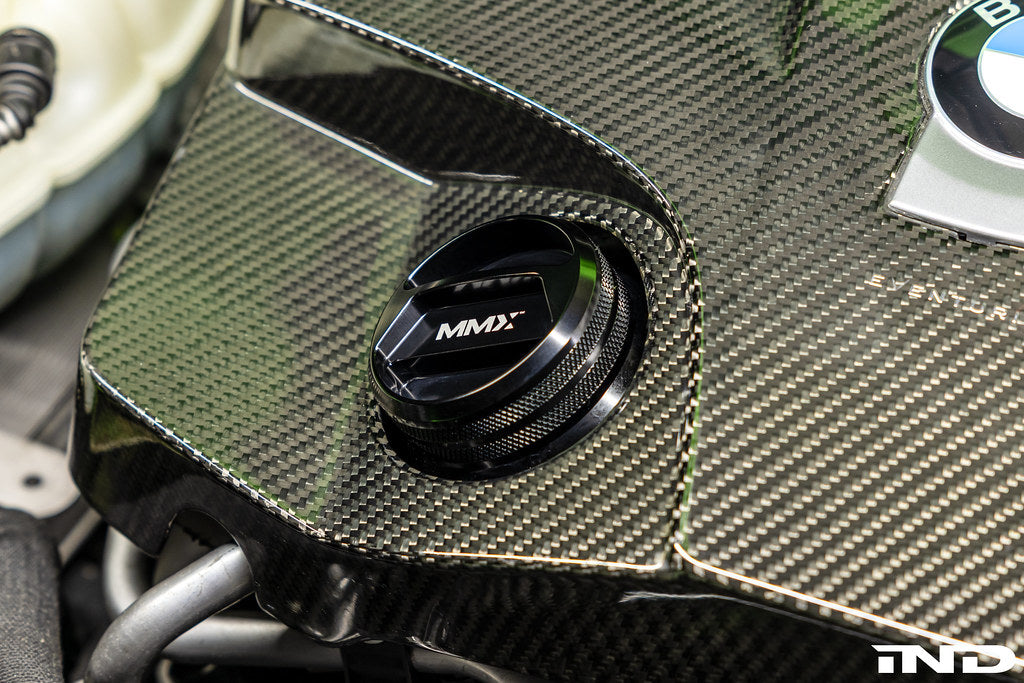 BMW engine with MMX Performance billet oil filler cap installed, showcasing a sleek, durable aluminum cap on the engine.
