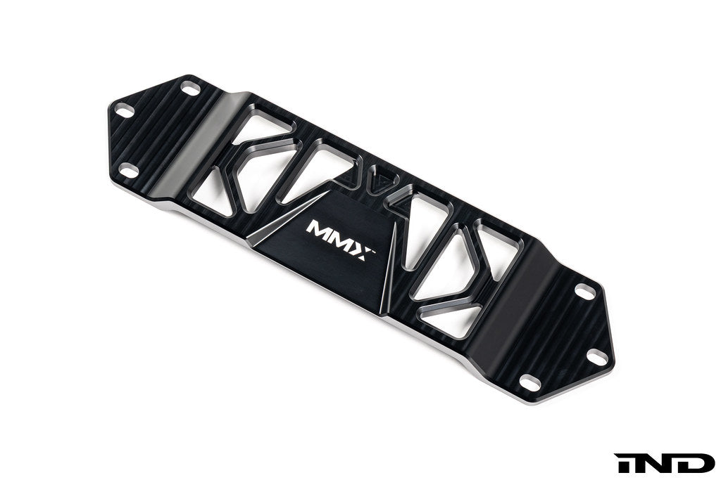MMX Performance BMW F8X Underbody Chassis Brace on a white background, precision CNC machined from billet 6061-T6 aluminum to increase exhaust clearance, improve chassis rigidity, and provide a direct OEM-fit installation for the F87 M2, M2 Competition, F80 M3, and F82/F83 M4.