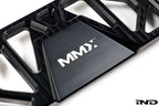 MMX Performance BMW F8X Underbody Chassis Brace on a white background, precision CNC machined from billet 6061-T6 aluminum to increase exhaust clearance, improve chassis rigidity, and provide a direct OEM-fit installation for the F87 M2, M2 Competition, F80 M3, and F82/F83 M4.