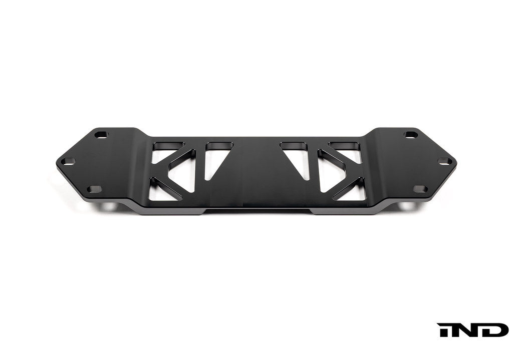 MMX Performance BMW F8X Underbody Chassis Brace on a white background, precision CNC machined from billet 6061-T6 aluminum to increase exhaust clearance, improve chassis rigidity, and provide a direct OEM-fit installation for the F87 M2, M2 Competition, F80 M3, and F82/F83 M4.