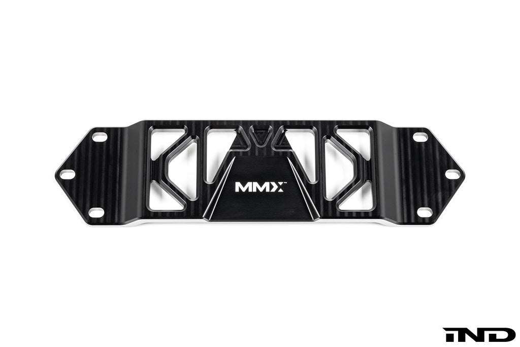 MMX Performance BMW F8X Underbody Chassis Brace on a white background, precision CNC machined from billet 6061-T6 aluminum to increase exhaust clearance, improve chassis rigidity, and provide a direct OEM-fit installation for the F87 M2, M2 Competition, F80 M3, and F82/F83 M4.