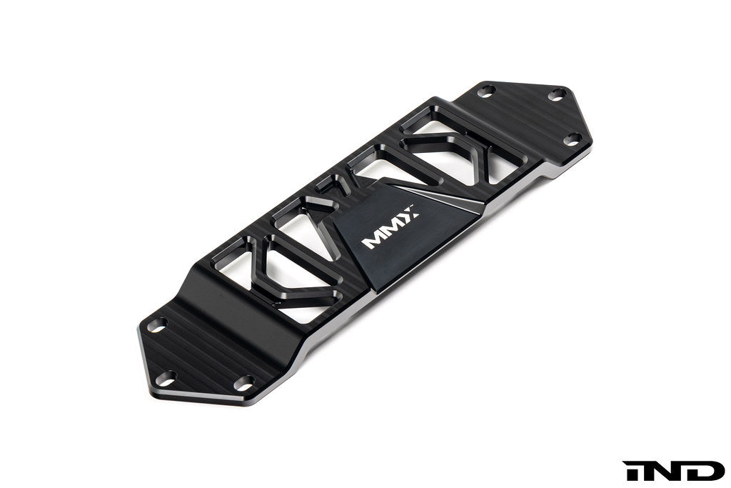 MMX Performance BMW F8X Underbody Chassis Brace on a white background, precision CNC machined from billet 6061-T6 aluminum to increase exhaust clearance, improve chassis rigidity, and provide a direct OEM-fit installation for the F87 M2, M2 Competition, F80 M3, and F82/F83 M4.