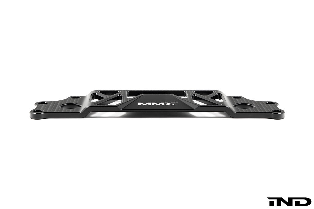 MMX Performance BMW G87 M2 Underbody Chassis Brace on a white background, precision CNC machined from billet 6061-T6 aluminum to provide additional exhaust clearance, increased chassis rigidity, and direct OEM-fit installation.