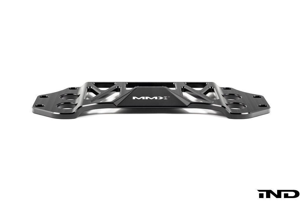 MMX Performance BMW G8X M3 and M4 billet 6061-T6 aluminum underbody chassis brace on a white background, designed to increase exhaust clearance and improve chassis rigidity for G80, G81, G82, and G83 models.