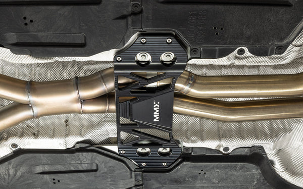 MMX Performance BMW G8X M3 and M4 Underbody Chassis Brace installed, showcasing the OEM fitment, factory mounting points, and precision billet 6061-T6 aluminum construction for a direct bolt-on installation.