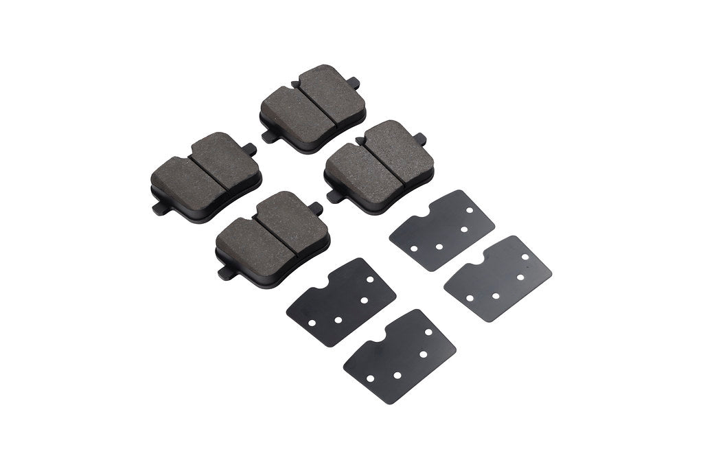 Race Technologies F90 M5 Competition Street Brake Pad Set with iron rotors, showcasing white brake pads and detailed brake components.