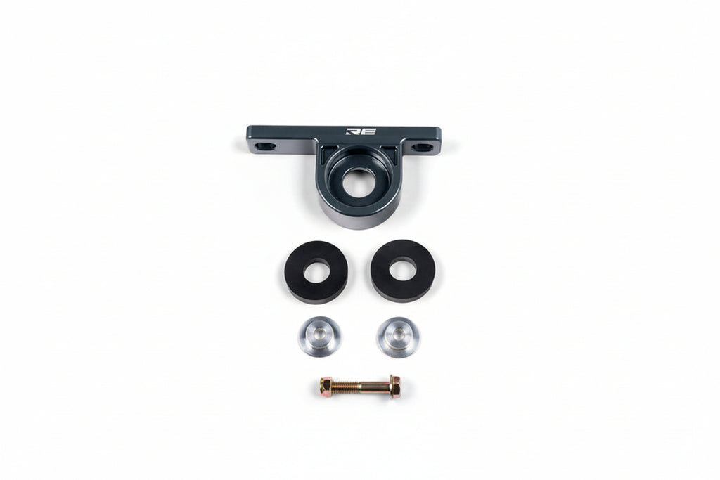 Rogue Engineering BMW E36/E46/E9X rear muffler hanger for exhaust system, white metal part attached to vehicle's rear.