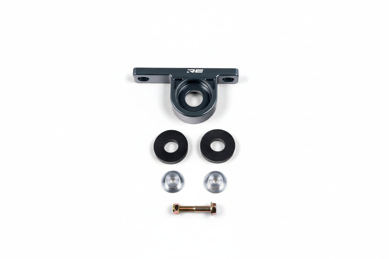 Rogue Engineering BMW E36/E46/E9X rear muffler hanger for exhaust system, white metal part attached to vehicle's rear.