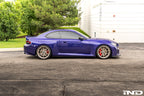 TREVORA carbon flat side skirts installed on a BMW G87 M2