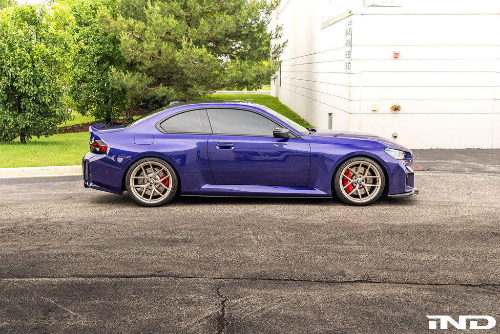TREVORA carbon flat side skirts installed on a BMW G87 M2