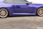 TREVORA carbon flat side skirts installed on a BMW G87 M2