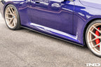 TREVORA carbon flat side skirts installed on a BMW G87 M2