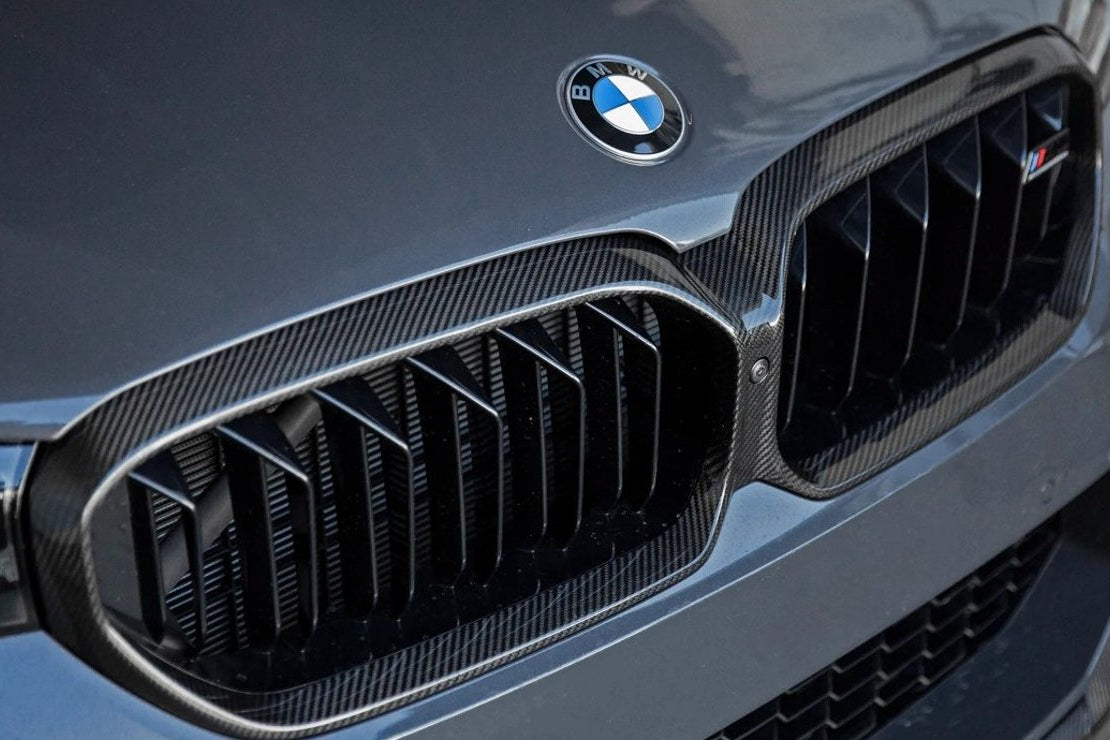 TREVORA G30 5-Series F90 M5 LCI pre-preg carbon fiber grille surround installed on front of vehicle.