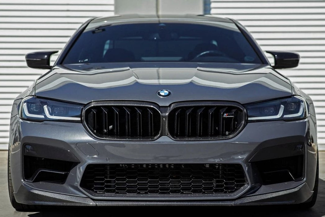 TREVORA G30 5-Series F90 M5 LCI pre-preg carbon fiber exterior grille surround installed on front of vehicle.