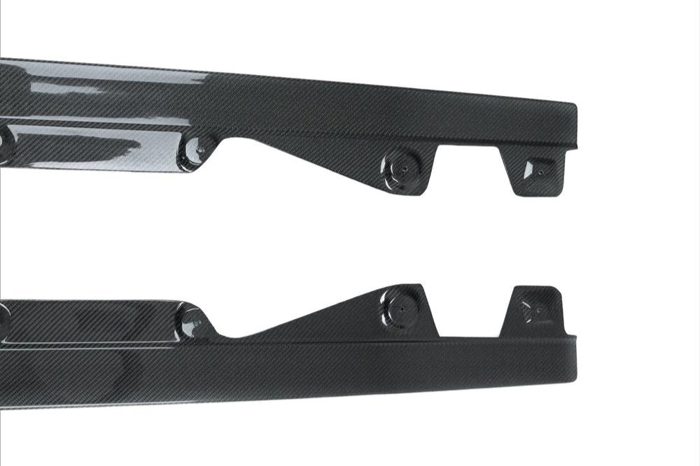 TREVORA G42 2-Series M240i carbon fiber side skirt set on a white exterior car, showcasing sleek, aerodynamic design.