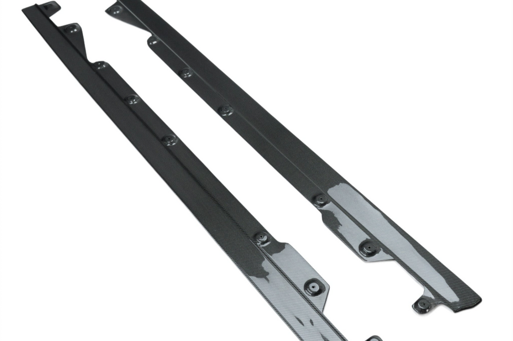 TREVORA G42 2-Series M240i carbon fiber side skirt set installed on white exterior of car, enhancing sporty appearance.