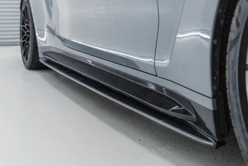Close-up of TREVORA G82 G83 M4 carbon fiber side skirts installed on the right front exterior, showcasing the sleek design.