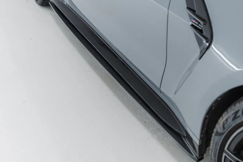 TREVORA G82 G83 M4 carbon fiber pre-preg side skirts installed on vehicle exterior, showcasing sleek, high-performance design.
