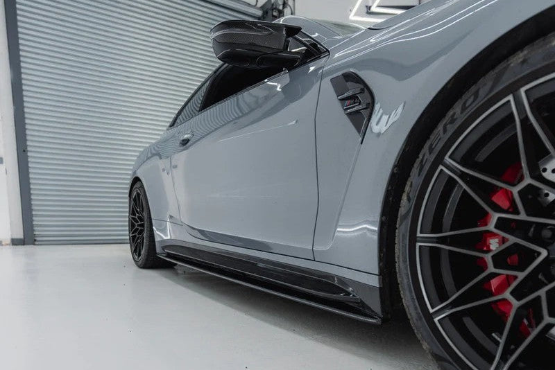 TREVORA G82 M4 Carbon Fiber Side Skirts installed on vehicle, showcasing sleek exterior design and high-quality pre-preg carbon fiber finish.