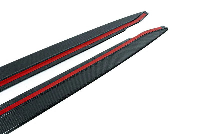 Pair of TREVORA G82 G83 M4 carbon fiber pre-preg side skirts, close-up view showing sleek exterior design on white background