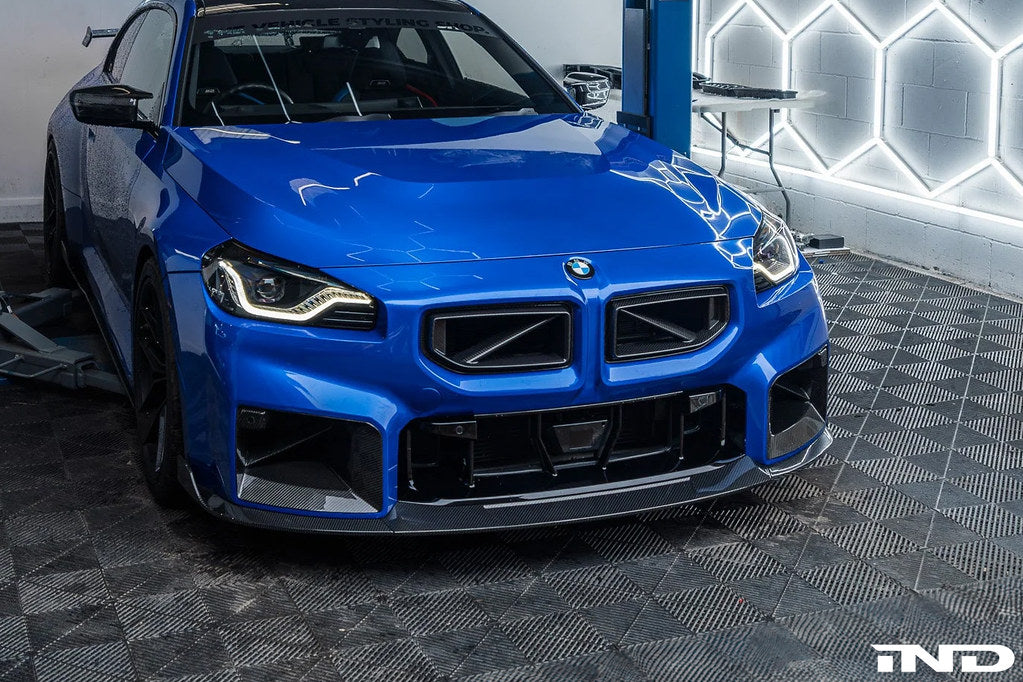 TREVORA G87 M2 carbon front splitter with winglets installed on a car, showcasing aerodynamic exterior enhancement.