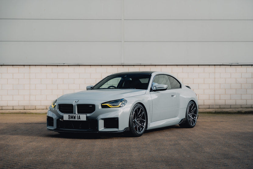 TREVORA G87 M2 Carbon front splitter with winglets installed on a BMW M2 exterior, showcasing aerodynamic upgrade details.