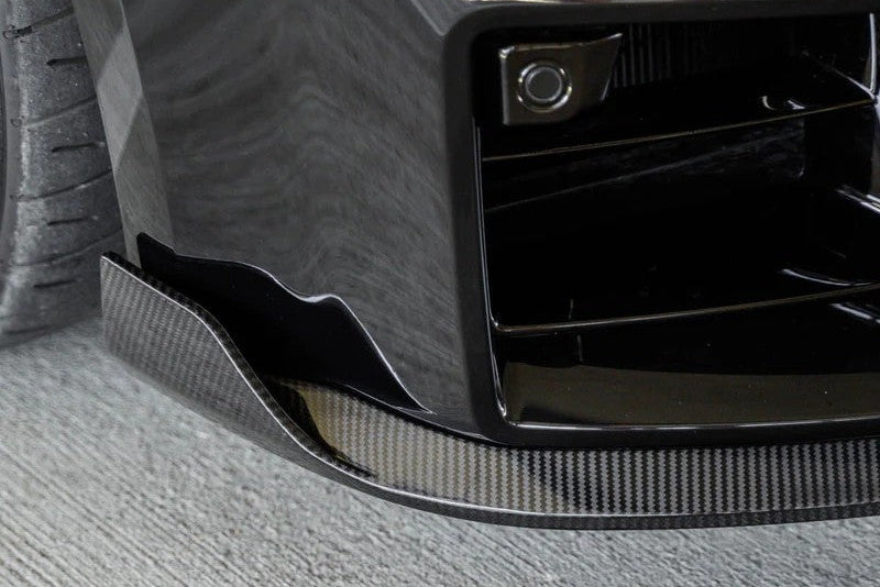 TREVORA G87 M2 Carbon front splitter with winglets installed on a BMW M2 exterior, showcasing aerodynamic design and performance features.