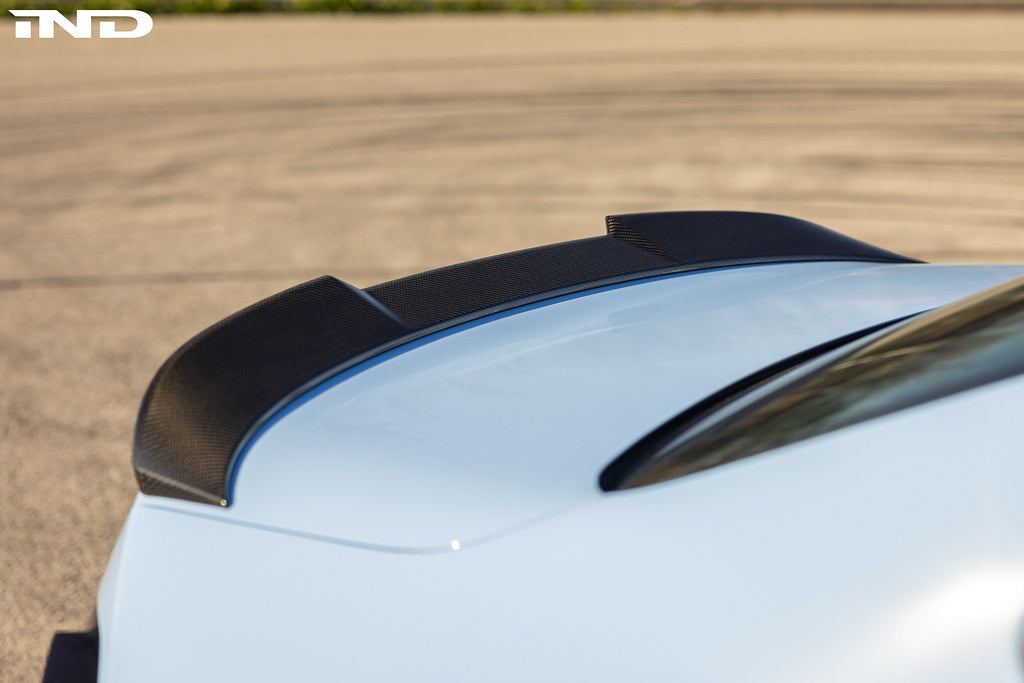 TREVORA G87 M2 Carbon rear spoiler installed on a car, showcasing a sleek, aerodynamic exterior upgrade for BMW M2.
