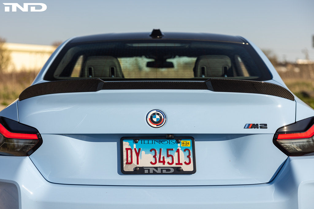 TREVORA G87 M2 Carbon rear spoiler installed on a car, showcasing sleek exterior design and aerodynamic features.
