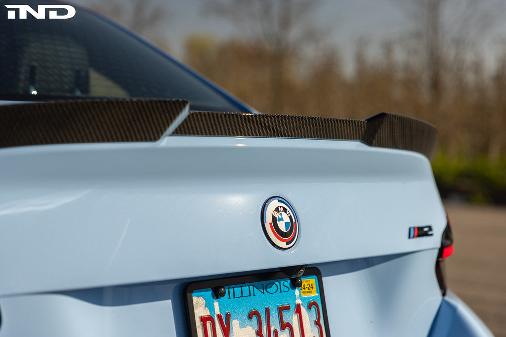TREVORA G87 M2 Carbon rear spoiler installed on vehicle, showcasing sleek exterior design and aerodynamic features.